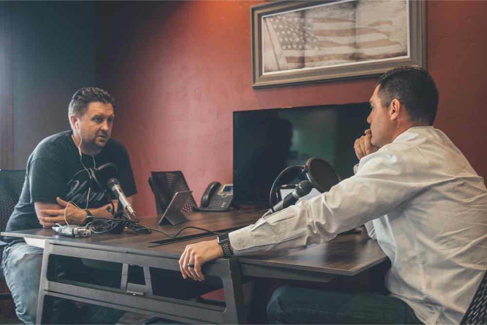 Two men recording a podcast in studio