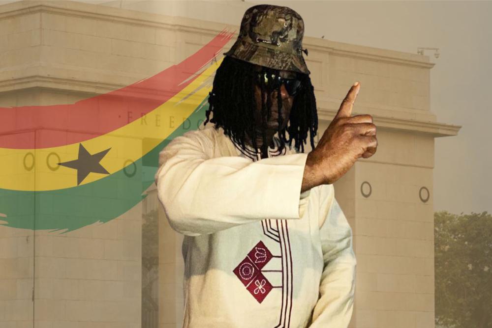 Man in traditional attire with Ghana flag